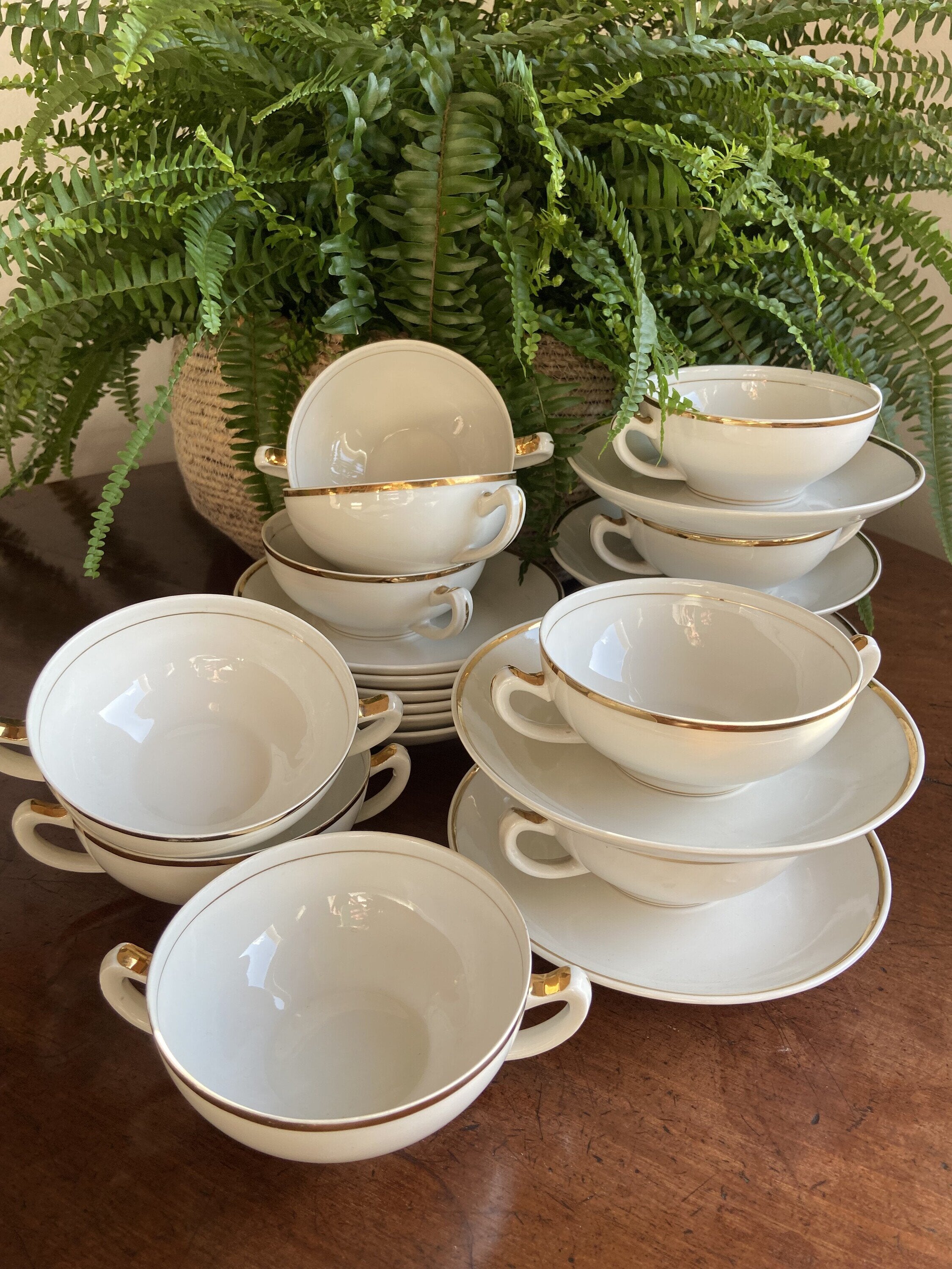 12 tazas de consomé en porcelana blanca con filo dorado